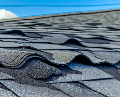 A photo of curled shingles on a roof