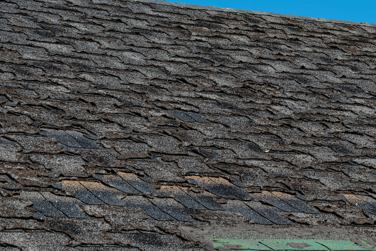Illustration of a worn-out roof with missing shingles and signs of damage