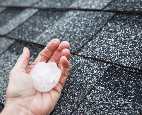 Illustration of roofing professionals conducting hail damage repairs