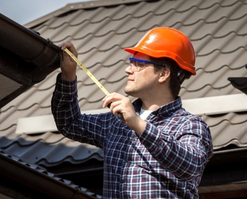 Illustration of a roof inspector checking for water damage and leaks around roof penetrations