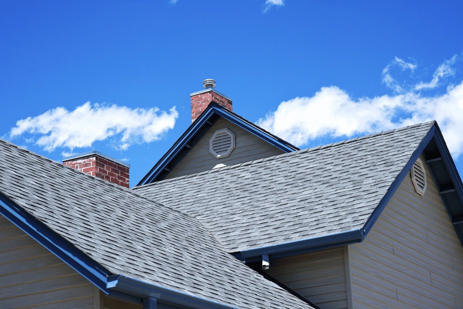 Illustration of a roof with a cricket diverting water away from a chimneys