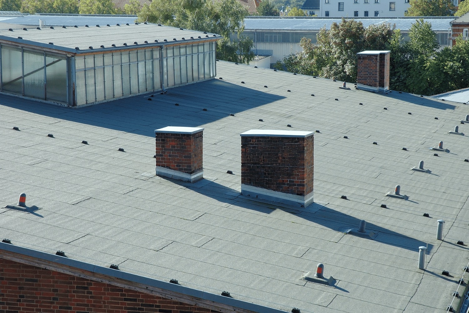 Illustration of a roof with and without crickets, highlighting the importance of roof crickets