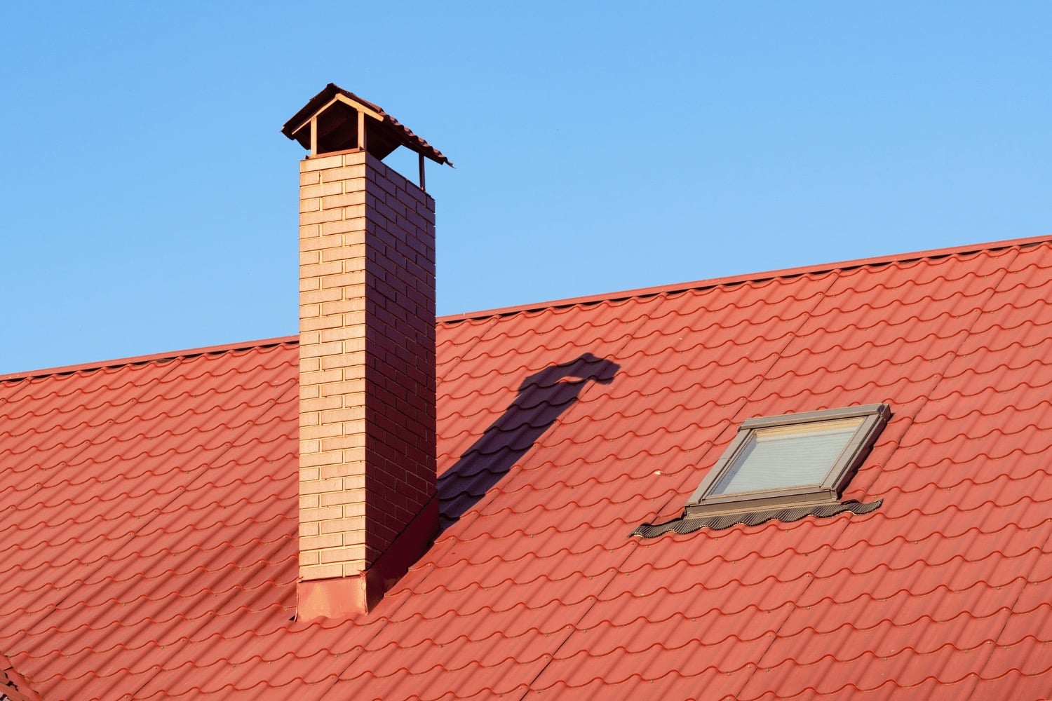 Illustration of different materials used for roof crickets including wood, sloped rigid insulation, and metal flashing