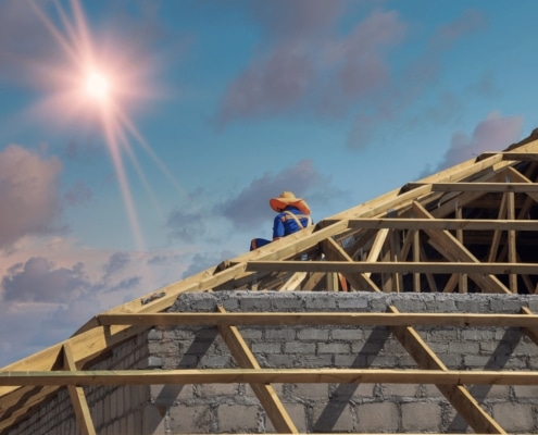 An illustration depicting a roof replacement process with a team of roofers.