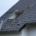 An illustration of a house showing gutters, siding, and skylights being installed.