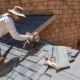 An illustration of a roofing contractor assessing a damaged roof for emergency repairs.