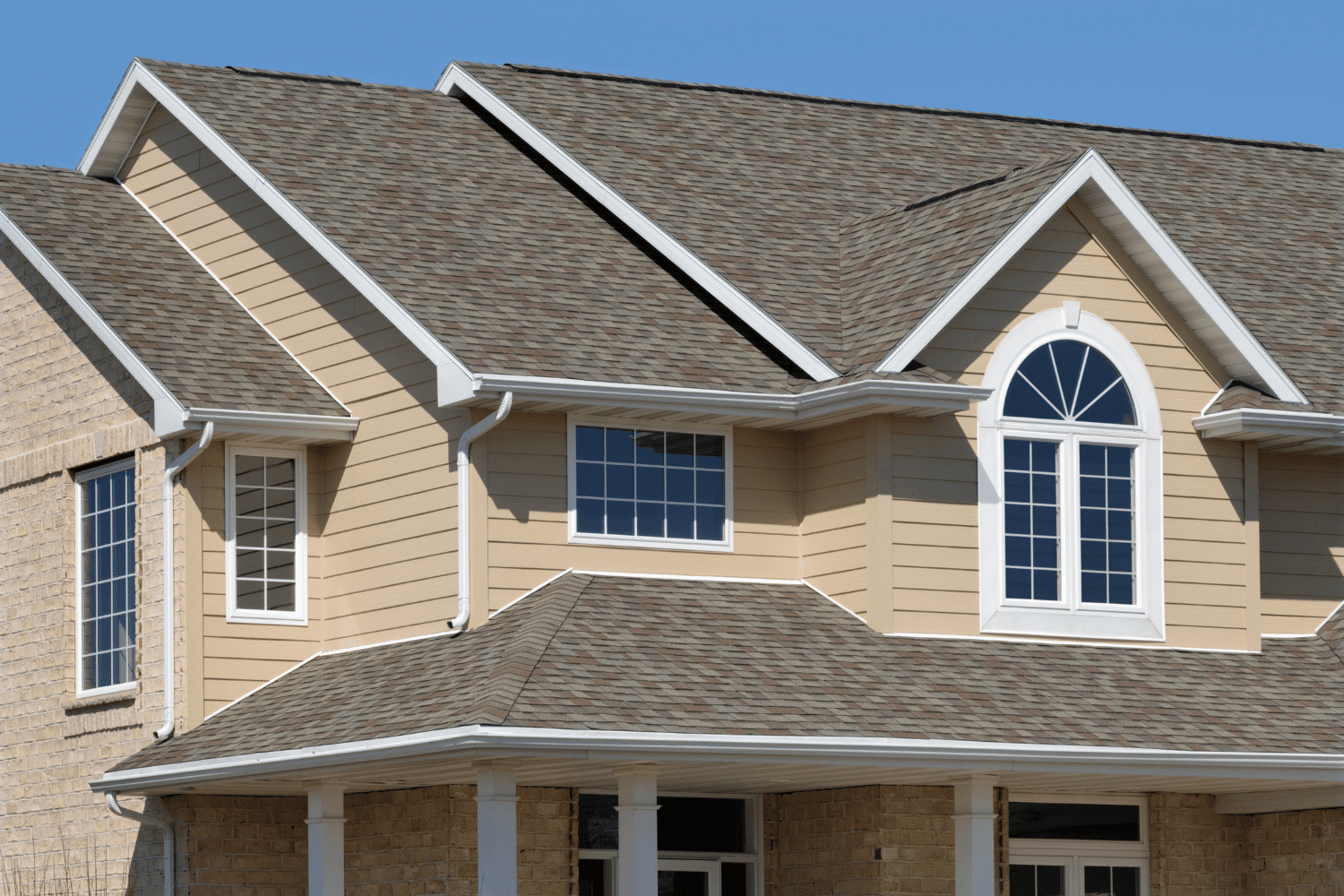 An illustration of different roofing materials including asphalt shingles and metal roofs.