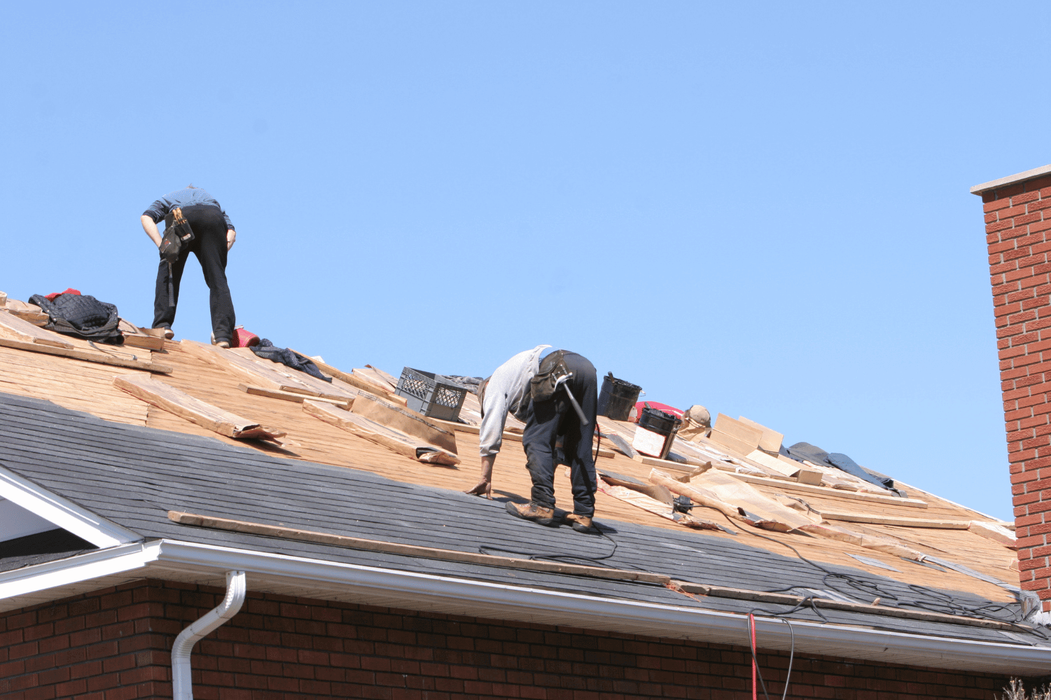 An illustration showing a house with a new roof being installed.