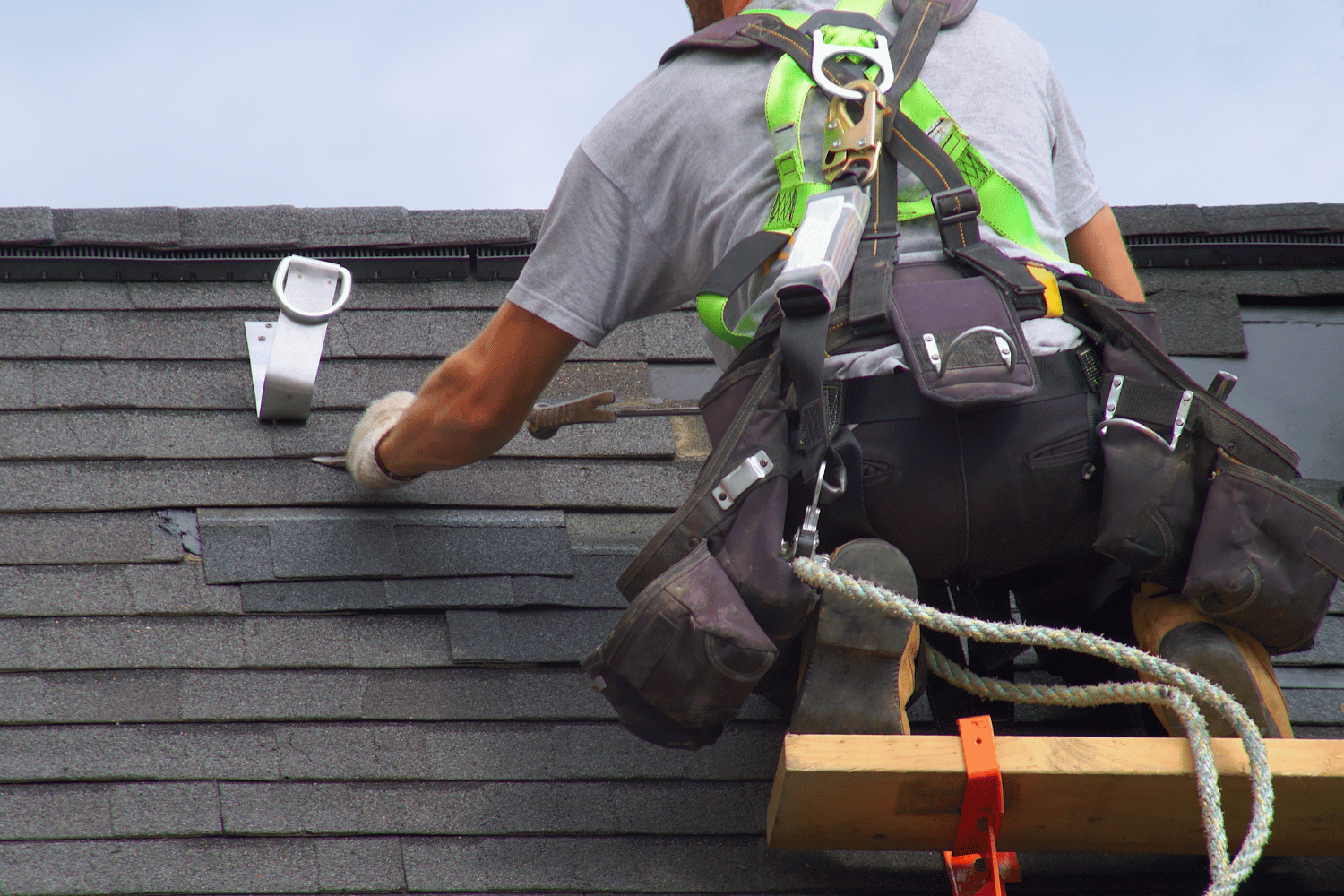 Applying roofing cement and drip edge on a roof.