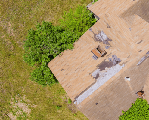 An image showing wind shingle damage on a roof.