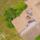 An image showing wind shingle damage on a roof.