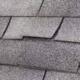 The image displays asphalt shingles, a common roofing material.