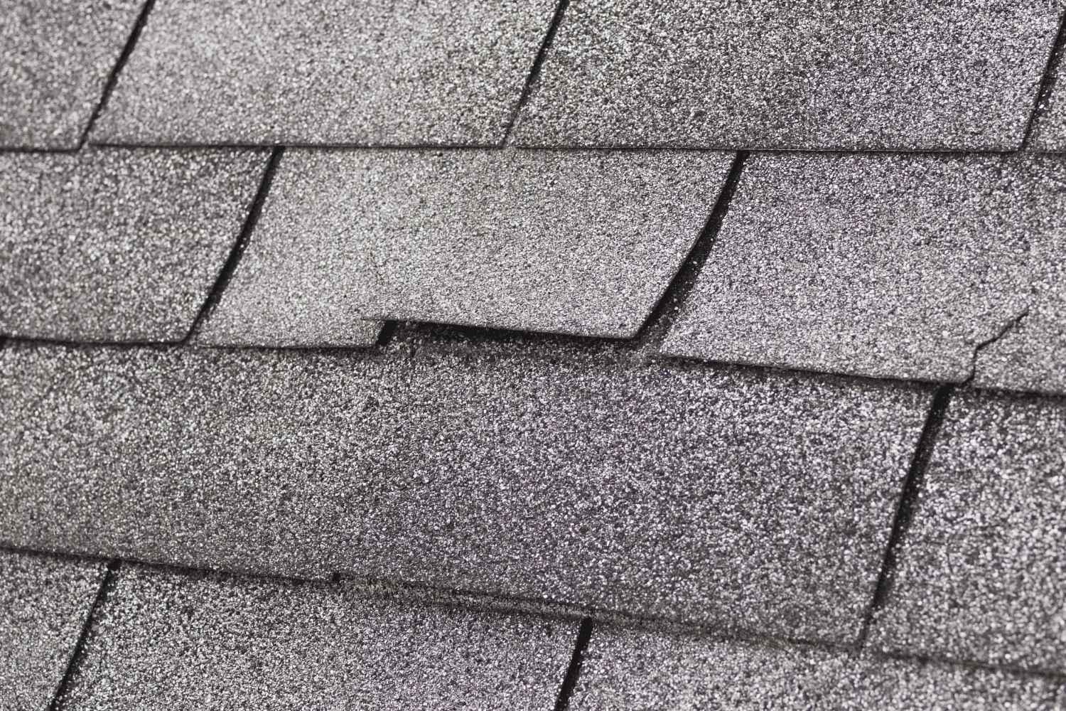 The image displays asphalt shingles, a common roofing material.