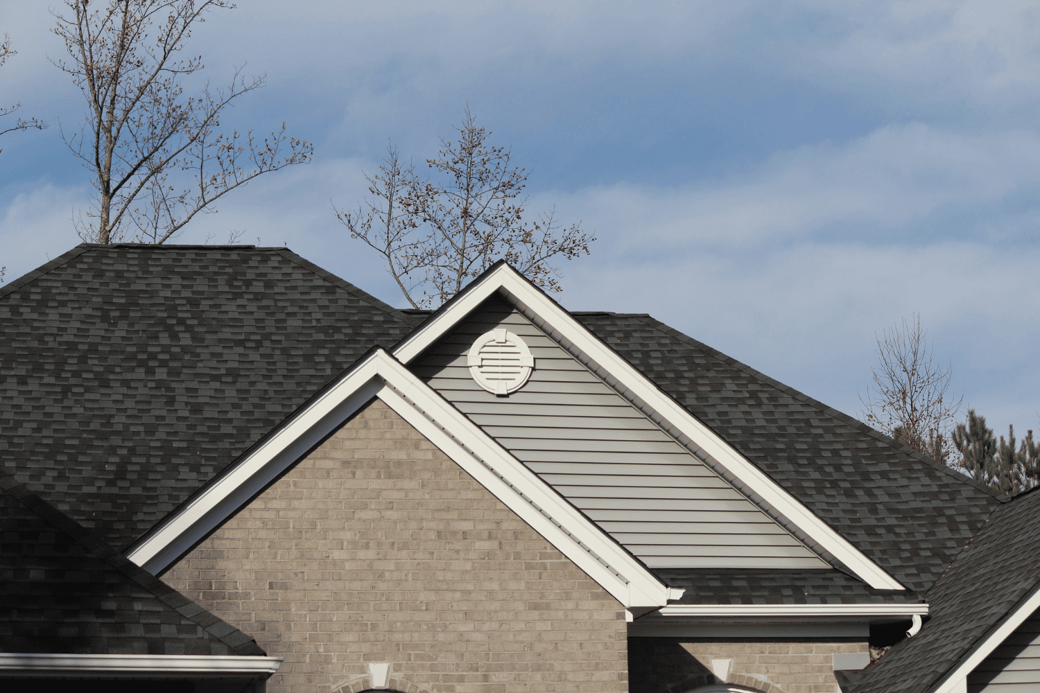 A demonstration of wind-resistant shingles being installed on a roof.