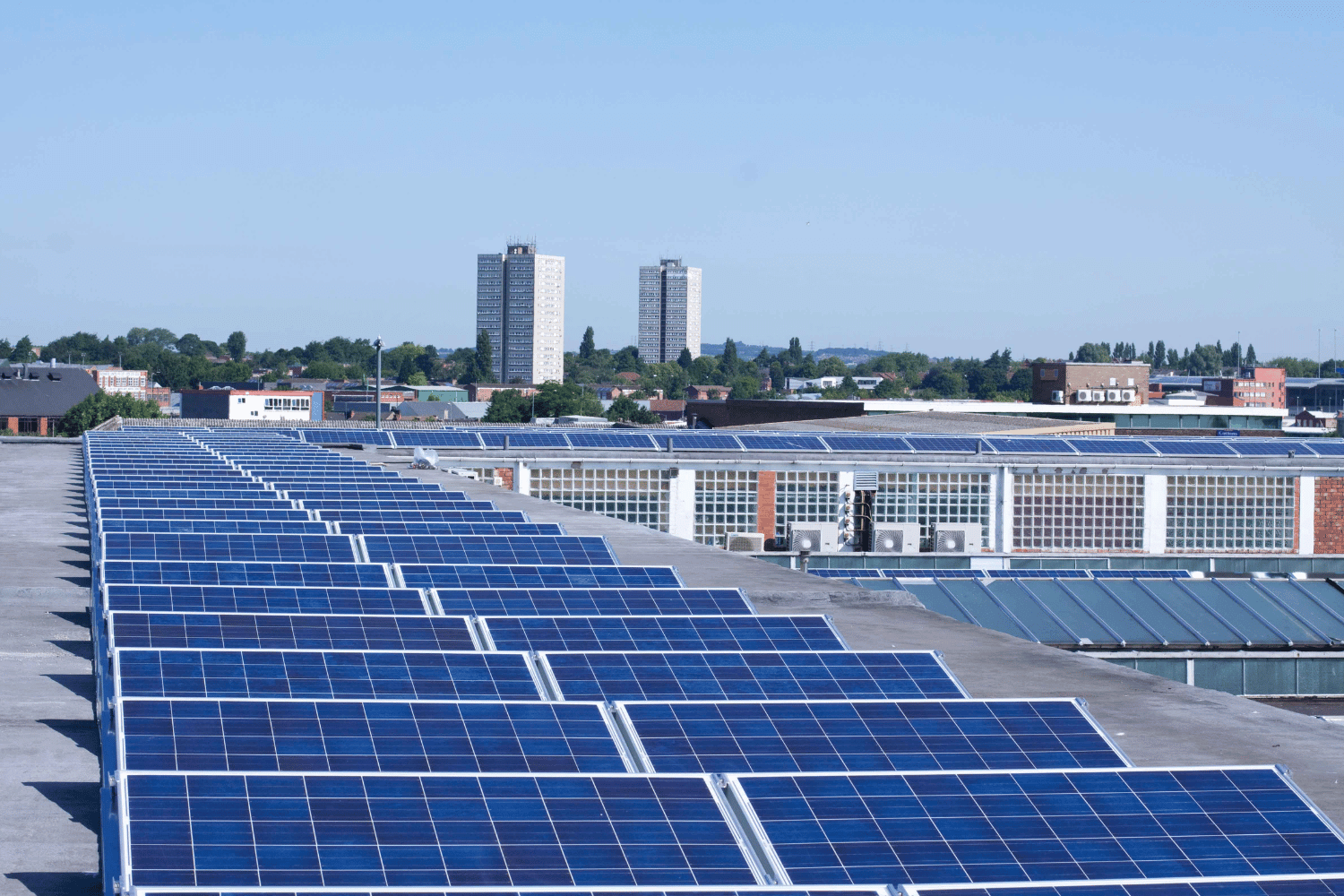 Flat roofs on commercial buildings with solar panels installed. 