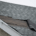 Signs indicating the need for roofline repair, including damaged shingles and water stains.