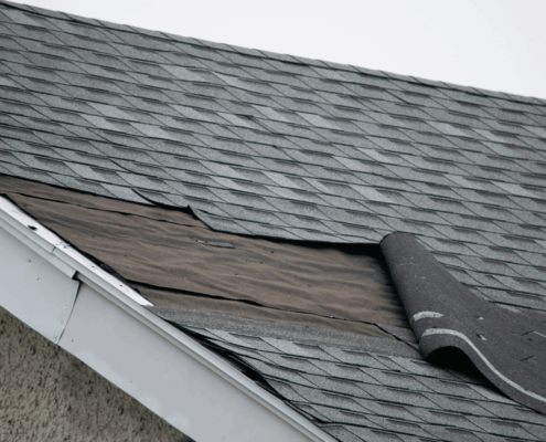 Signs indicating the need for roofline repair, including damaged shingles and water stains.