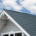 Installation best practices for roof insulation boards, featuring a worker installing rigid foam insulation.