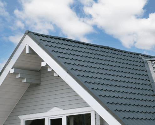 Installation best practices for roof insulation boards, featuring a worker installing rigid foam insulation.