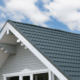 Installation best practices for roof insulation boards, featuring a worker installing rigid foam insulation.