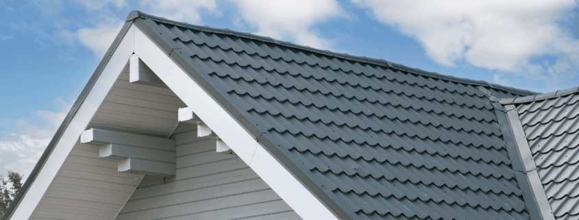 Installation best practices for roof insulation boards, featuring a worker installing rigid foam insulation.